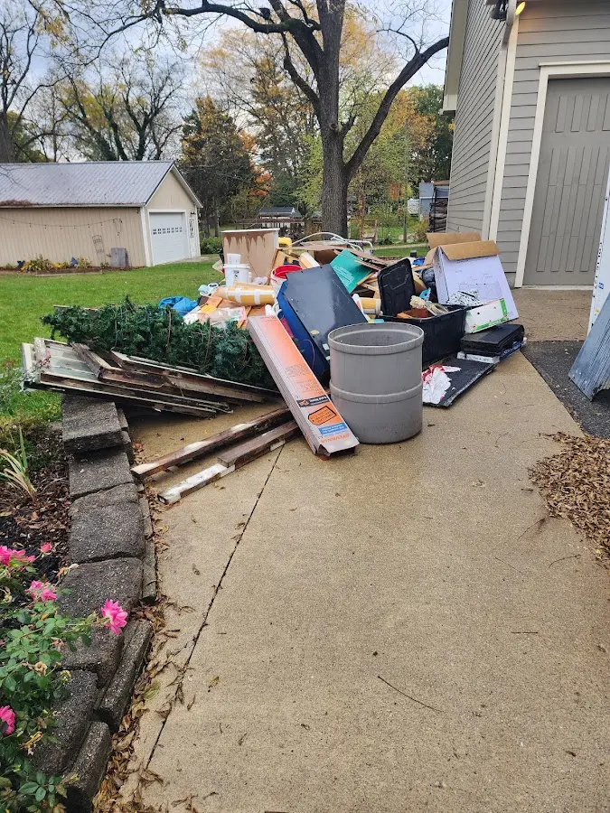 Dumpster being loaded with debris for Roofing Dumpster Rental in Oxford